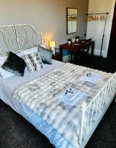 a large bed with two plates of food on it at The Lincoln Arms Pub & Rooms in Dorking +13 photos