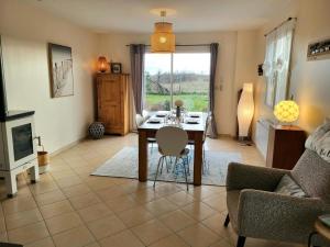 a living room with a table and chairs and a couch at Villa Des Havres in Saint-Germain-sur-Ay +23 photos