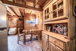a kitchen with a table and chairs in a cabin at Chalet 6p Classique - Les Gentianes in Verchaix