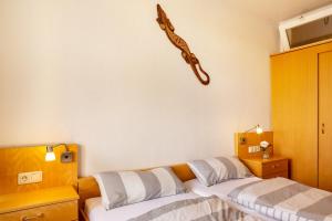 a bedroom with two beds and a guitar on the wall at Gemütliche Fewo im schönen Harz in Braunlage +25 photos