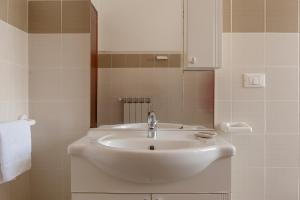 a bathroom with a white sink and a mirror at Bandb Cindy in Navacchio +43 photos