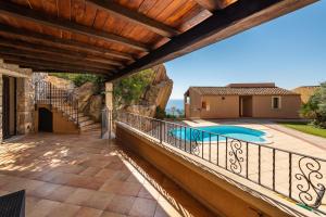a balcony with a view of a swimming pool at Villa Simonetta n9 in Costa Rei