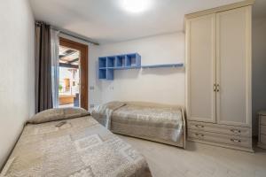 a bedroom with two beds and a window at Villa Simonetta n9 in Costa Rei +33 photos