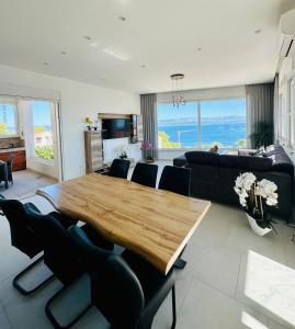 a living room with a wooden table and a couch at Villa Jasmina in Stomorska