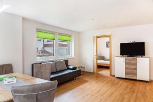 a living room with a couch and a television at Haus Florian Ski-in and Ski-out in See