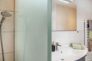 a bathroom with a shower and a sink at Haus Florian Ski-in and Ski-out in See +16 photos