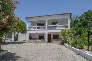 a white house with a patio in front of it at Casa El Molino in Montecorto