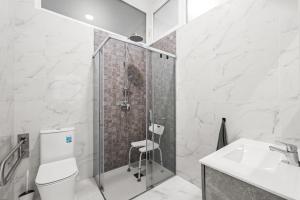 a bathroom with a shower and a toilet and a sink at Vima Lofts in Torrevieja +101 photos