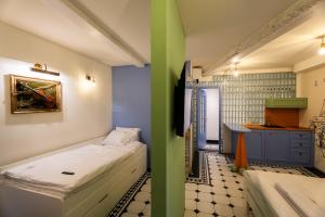 a room with two beds and a kitchen at Casa Libertà Suites & Studios Piran in Piran