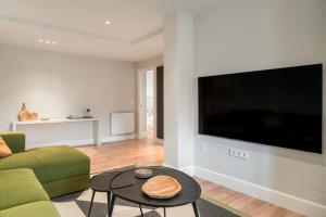 a living room with a large flat screen tv at 'Salmosalar' Cangas de Onís in Cangas de Onís