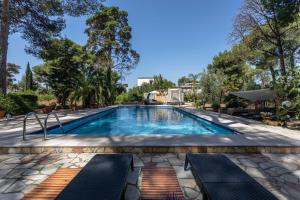 a swimming pool with two chaise lounges next to a resort at Villa Sole With Pool and Sauna in Lecce