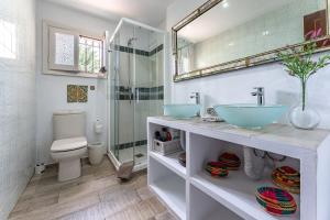 a bathroom with two sinks and a shower at Art Gallery House in La Cala de Mijas +31 photos
