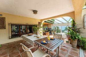a dining room with a table and chairs at Art Gallery House in La Cala de Mijas