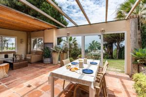 a conservatory with a table and chairs on a patio at Art Gallery House in La Cala de Mijas