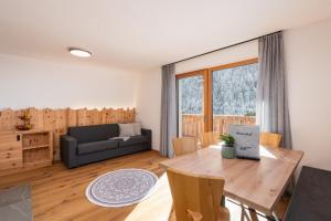 a living room with a table and a couch at Huberhof Gais in Gais