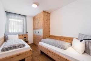 a bedroom with two beds and a window at Huberhof Gais in Gais