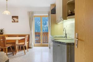 a kitchen with a table and a dining room at Unterzerunhof 2 in Laion +24 photos