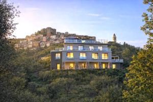 a house on top of a hill with a building at Le Stele Hotel in Lerici
