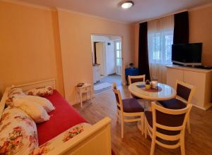 a bedroom with a bed and a table and a dining room at Apartment with Sunset terrace in Mlini