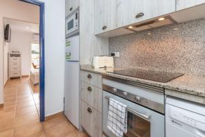 a kitchen with a stove and a counter top at La caseta de Sa Riera in Begur