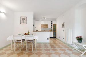 a kitchen and dining room with a table and chairs at Vallelaghi Escape in Terlago +25 photos