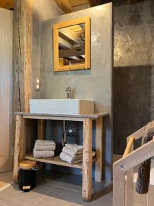 a bathroom with a sink on a table with towels at Gite les 4 Saisons in Ombre