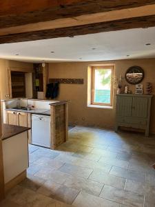 a large kitchen with a counter and a window at Gite les 4 Saisons in Ombre