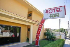 a hotel ad sign in front of a building at Hotel Abib in Irati