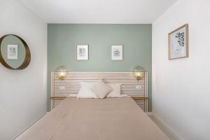a bedroom with a bed and a mirror at Blava in Begur +27 photos