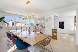 a dining room and kitchen with a table and chairs at Blava in Begur