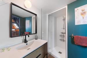 a bathroom with a sink and a mirror at L'Ancrage - Maison 17è - Port in Camaret-sur-Mer