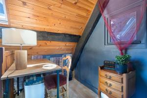 a desk in a room with a wooden ceiling at L'Ancrage - Maison 17è - Port in Camaret-sur-Mer +13 photos