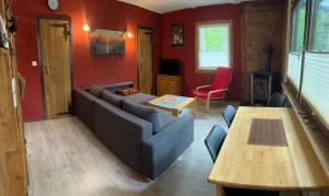 a living room with a couch and a table at Haus Sonnenschein in Dranske
