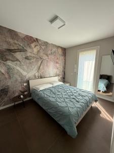 a bedroom with a bed and a painting on the wall at Residenza San Rocco in Pedemonte