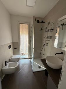 a white bathroom with two sinks and a shower at Residenza San Rocco in Pedemonte