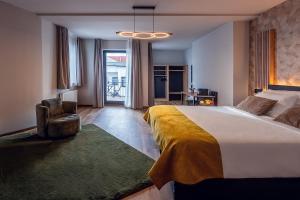 a bedroom with a large bed with a yellow blanket at Residency NO7 in Berlin