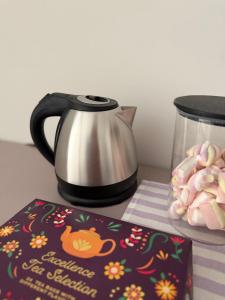 a tea kettle and a cake on a table at Residenza San Rocco in Pedemonte