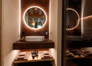 a bathroom with a sink and a mirror at Chalet Ice Villa Genf Spa - Relax in Livigno +34 photos