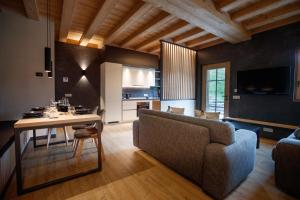 a living room with a couch and a table at Chalet Ice Villa Genf Spa - Relax in Livigno