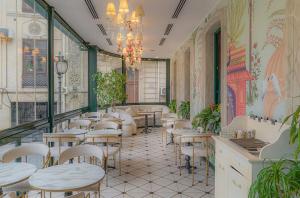 a restaurant with tables and chairs in a room at Retro Silent Boutique Hotel in Baku