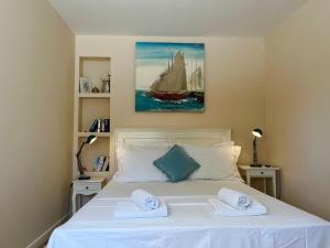 a bedroom with a white bed with two towels at Apartment with Sunset terrace in Mlini +30 photos