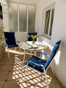 a patio with a table and chairs on a balcony at Apartment with Sunset terrace in Mlini