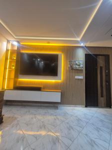 a living room with a large television on a wall at Appartement rif roayal in Al Hoceïma