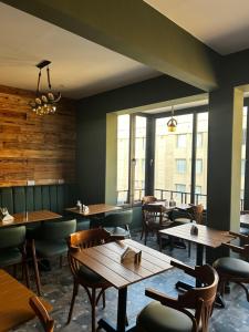 a restaurant with wooden tables and chairs and windows at Museum Plaza in Cairo