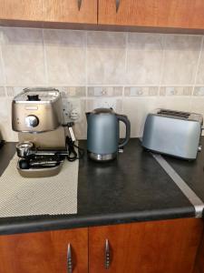 a kitchen counter with two toasters and a toaster at 77 on First! in Fish Hoek