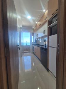 a large kitchen with a view of the ocean at Appartement rif roayal in Al Hoceïma