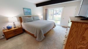 a bedroom with a bed and a large window at 74 Meadow House in Sunriver +12 photos