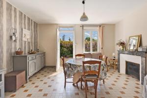 a kitchen and dining room with a table and chairs at Gîte Le Trotteur in Monteaux +15 photos