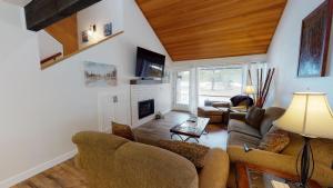 a living room with a couch and a fireplace at 79 Meadow House in Sunriver
