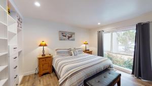 a bedroom with a bed and a window at 79 Meadow House in Sunriver +18 photos
